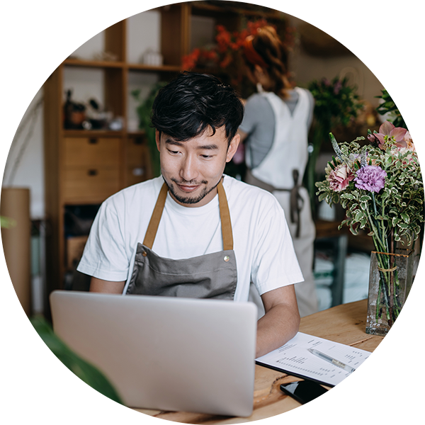 A man working in front of a computer in a flower shop.